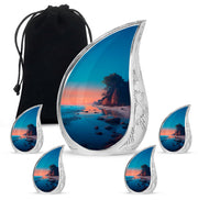 Jewel Teal Beach Cremation Urn side profile showing urn shape - flowing teardrop beach silhouette on curved aluminum - memorial set with one large and four small urns