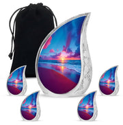 Misty Blue Beach Cremation Urn side profile showing urn shape - flowing teardrop beach silhouette on curved aluminum - memorial set with one large and four small urns
