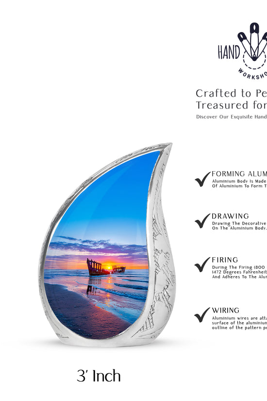 Celestial Blue Beach Cremation Urn angled view of lid and engraved motif - flowing teardrop beach silhouette on curved aluminum - mini keepsake memorial for portion of cremation ashes