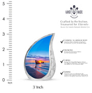Celestial Blue Beach Cremation Urn angled view of lid and engraved motif - flowing teardrop beach silhouette on curved aluminum - mini keepsake memorial for portion of cremation ashes