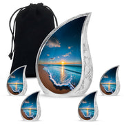 Misty Blue Beach Cremation Urn side profile showing urn shape - flowing teardrop beach silhouette on curved aluminum - memorial set with one large and four small urns
