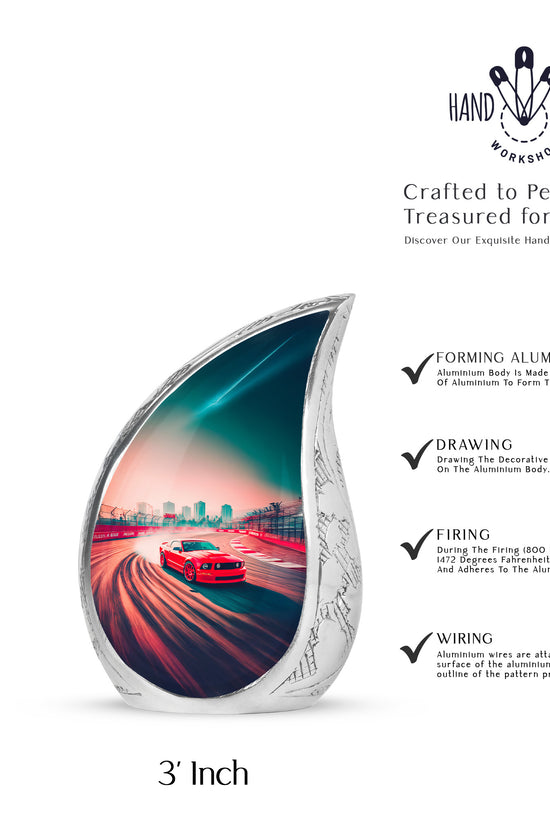 Ruby Red Car Cremation Urn angled view of lid and engraved motif - graceful tear-shaped urn with car motif - mini keepsake memorial for portion of cremation ashes