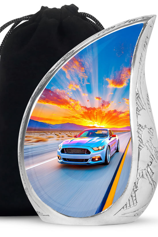 Powder Blue Car Cremation Urn front view showing detailed design - flowing teardrop car silhouette on curved aluminum - full-size 10 inch 200 cubic inch adult cremation urn