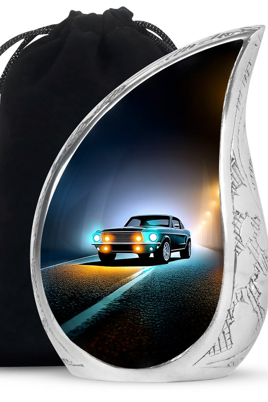 Rich Black Car Cremation Urn front view showing detailed design - flowing teardrop car silhouette on curved aluminum - full-size 10 inch 200 cubic inch adult cremation urn