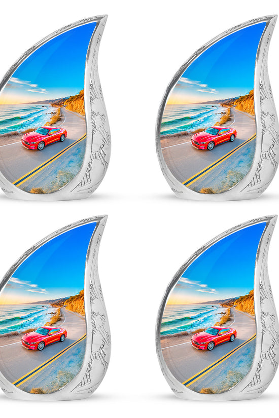 Soft Blue Car Cremation Urn close-up of engraving and surface detail - smooth teardrop contour featuring car art - 10 inch aluminum urn for cremated remains