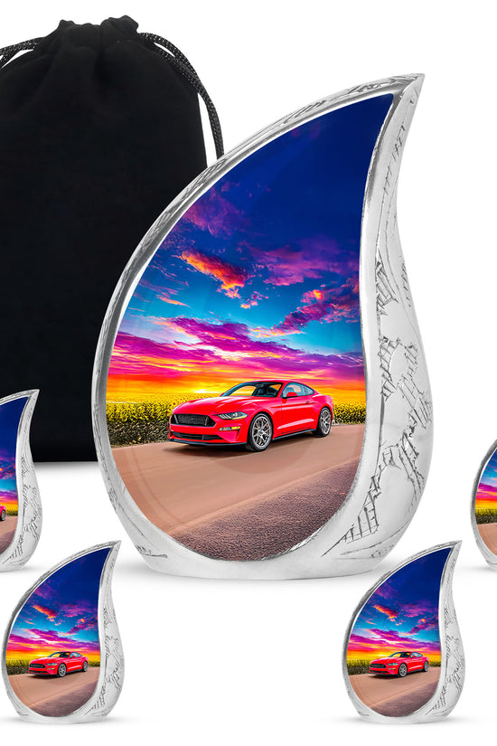 Indigo Car Cremation Urn side profile showing urn shape - flowing teardrop car silhouette on curved aluminum - memorial set with one large and four small urns