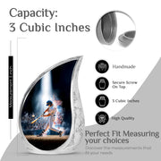 Onyx Black Baseball Cremation Urn angled view of lid and engraved motif - smooth teardrop contour featuring baseball art - mini keepsake memorial for portion of cremation ashes