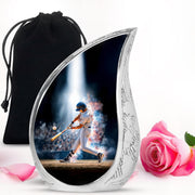 Deep Black Baseball Cremation Urn front view showing detailed design - flowing teardrop baseball silhouette on curved aluminum - full-size 10 inch 200 cubic inch adult cremation urn