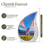 Indigo Baseball Cremation Urn angled view of lid and engraved motif - flowing teardrop baseball silhouette on curved aluminum - mini keepsake memorial for portion of cremation ashes