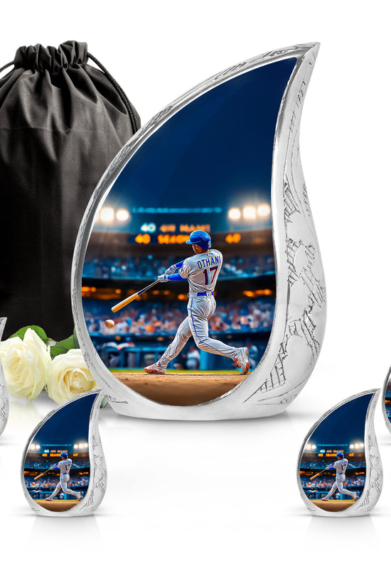 Slate Blue Baseball Cremation Urn side profile showing urn shape - flowing teardrop baseball silhouette on curved aluminum - memorial set with one large and four small urns