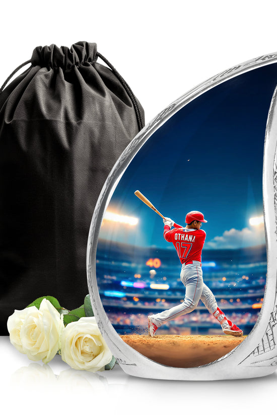 Powder Blue Baseball Cremation Urn front view showing detailed design - flowing teardrop baseball silhouette on curved aluminum - full-size 10 inch 200 cubic inch adult cremation urn