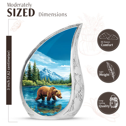 Pastel Blue Bear Cremation Urn angled view of lid and engraved motif - flowing teardrop bear silhouette on curved aluminum - mini keepsake memorial for portion of cremation ashes