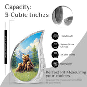 Soft Blue Bear Cremation Urn angled view of lid and engraved motif - smooth teardrop contour featuring bear art - mini keepsake memorial for portion of cremation ashes