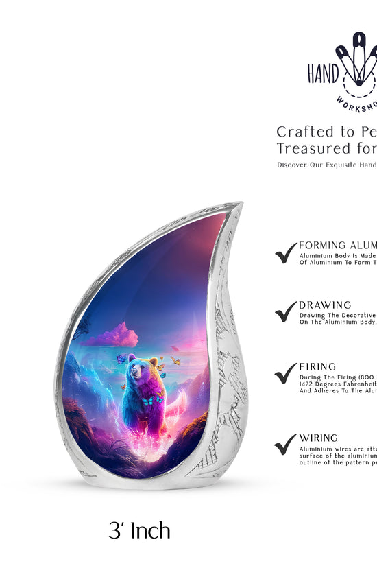 Misty Blue Bear Cremation Urn angled view of lid and engraved motif - flowing teardrop bear silhouette on curved aluminum - mini keepsake memorial for portion of cremation ashes