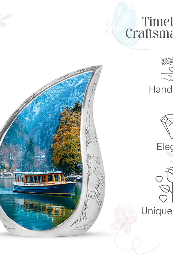 Serene Blue Boat Cremation Urn angled view of lid and engraved motif - smooth teardrop contour featuring boat art - mini keepsake memorial for portion of cremation ashes