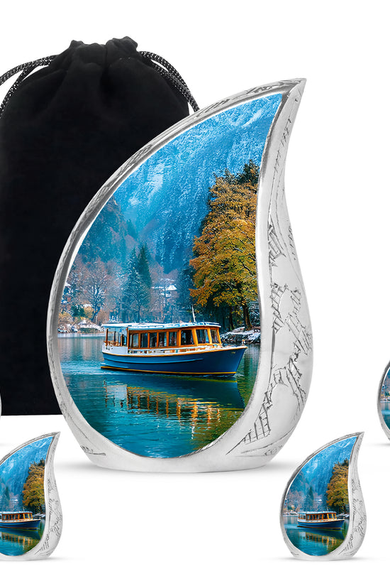 Azure Boat Cremation Urn side profile showing urn shape - flowing teardrop boat silhouette on curved aluminum - memorial set with one large and four small urns