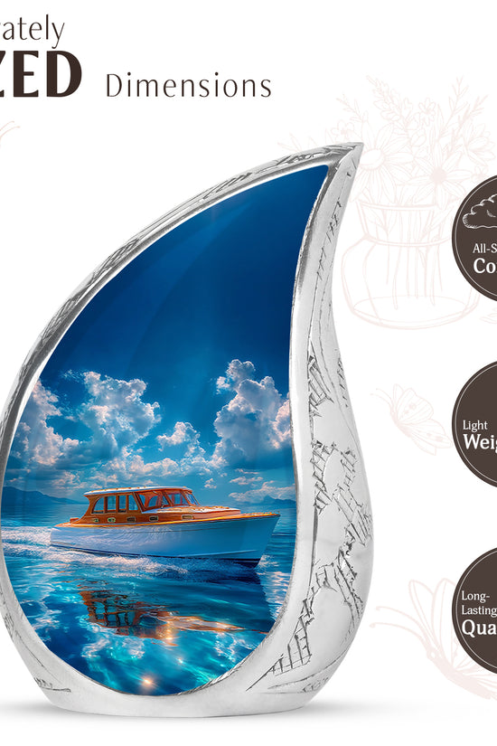 Cobalt Blue Boat Cremation Urn angled view of lid and engraved motif - graceful tear-shaped urn with boat motif - mini keepsake memorial for portion of cremation ashes