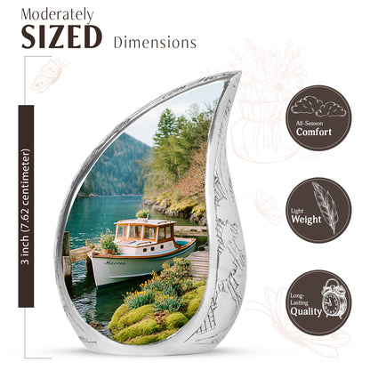 Ocean Teal Boat Cremation Urn angled view of lid and engraved motif - flowing teardrop boat silhouette on curved aluminum - mini keepsake memorial for portion of cremation ashes