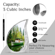 Pine Green Boat Cremation Urn angled view of lid and engraved motif - smooth teardrop contour featuring boat art - mini keepsake memorial for portion of cremation ashes