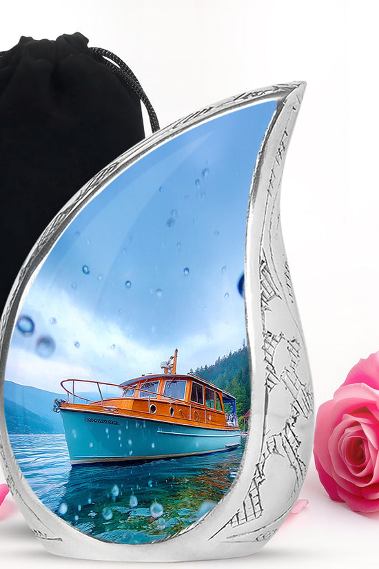 Misty Blue Boat Cremation Urn front view showing detailed design - flowing teardrop boat silhouette on curved aluminum - full-size 10 inch 200 cubic inch adult cremation urn