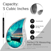 Aqua Teal Boat Cremation Urn angled view of lid and engraved motif - smooth teardrop contour featuring boat art - mini keepsake memorial for portion of cremation ashes