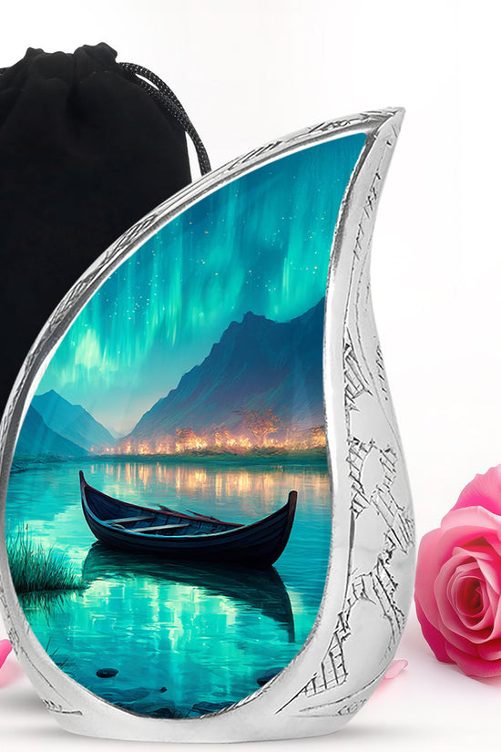 Ocean Teal Boat Cremation Urn front view showing detailed design - flowing teardrop boat silhouette on curved aluminum - full-size 10 inch 200 cubic inch adult cremation urn