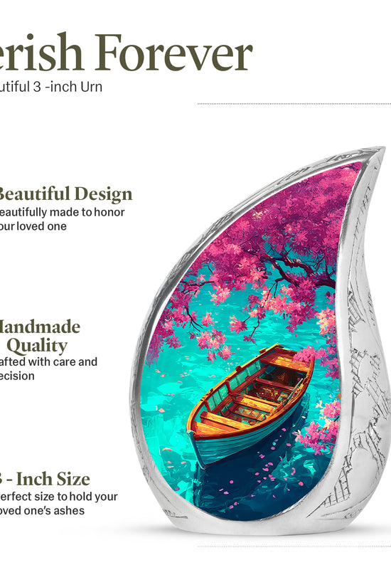 Deep Teal Boat Cremation Urn angled view of lid and engraved motif - smooth teardrop contour featuring boat art - mini keepsake memorial for portion of cremation ashes