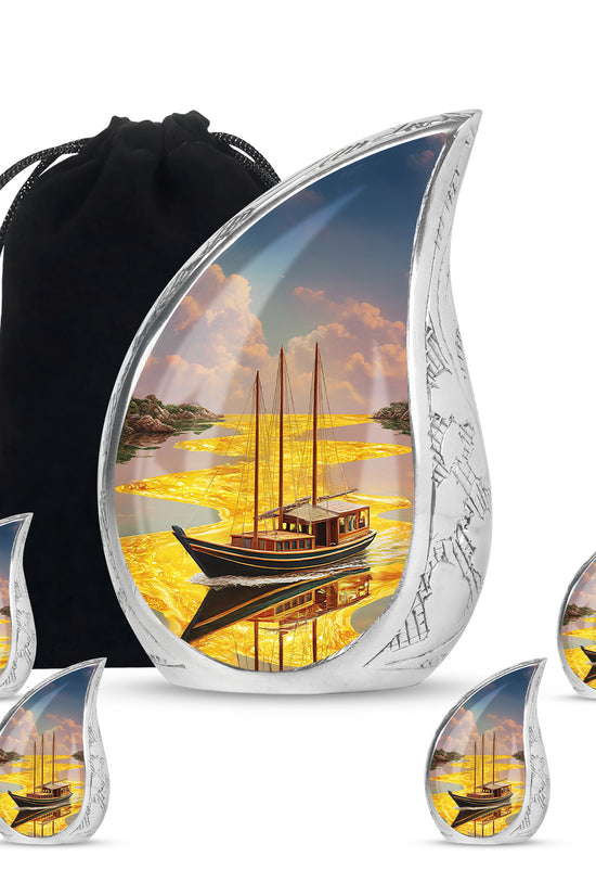 Royal Gold Boat Cremation Urn side profile showing urn shape - smooth teardrop contour featuring boat art - memorial set with one large and four small urns