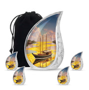 Royal Gold Boat Cremation Urn side profile showing urn shape - smooth teardrop contour featuring boat art - memorial set with one large and four small urns