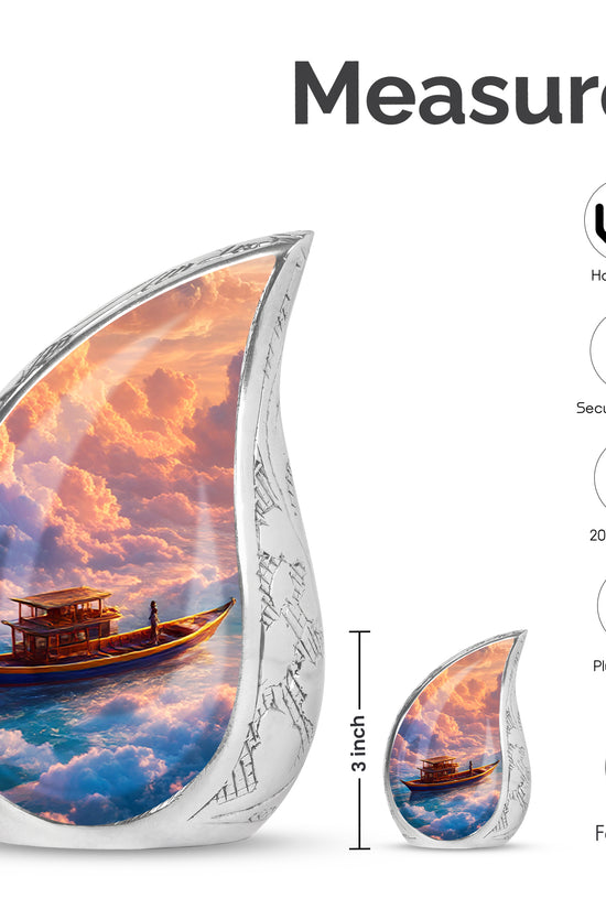 Rich Red Boat Cremation Urn angled view of lid and engraved motif - graceful tear-shaped urn with boat motif - mini keepsake memorial for portion of cremation ashes