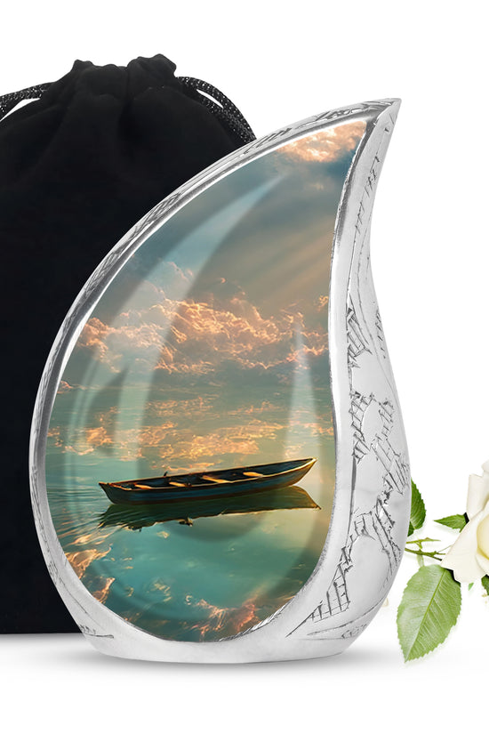Onyx Black Boat Cremation Urn front view showing detailed design - smooth teardrop contour featuring boat art - full-size 10 inch 200 cubic inch adult cremation urn