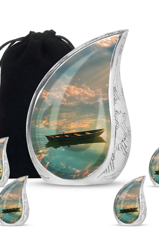 Ebony Boat Cremation Urn side profile showing urn shape - rounded teardrop boat design with delicate detail - memorial set with one large and four small urns