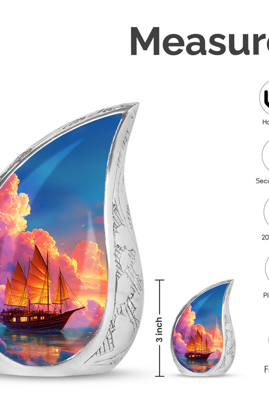 Dusty Blue Boat Cremation Urn angled view of lid and engraved motif - flowing teardrop boat silhouette on curved aluminum - mini keepsake memorial for portion of cremation ashes