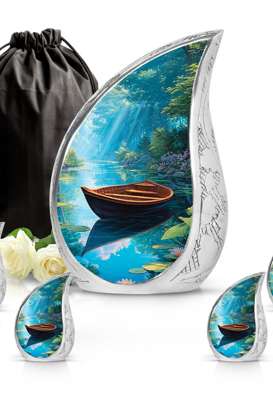 Dusty Blue Boat Cremation Urn side profile showing urn shape - rounded teardrop boat design with delicate detail - memorial set with one large and four small urns