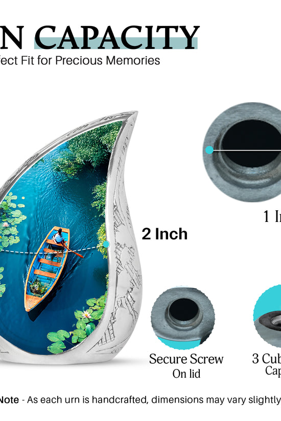 Deep Teal Boat Cremation Urn angled view of lid and engraved motif - smooth teardrop contour featuring boat art - mini keepsake memorial for portion of cremation ashes