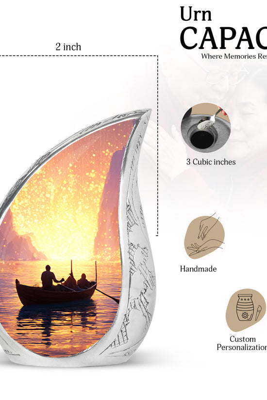 Cherry Red Boat Cremation Urn angled view of lid and engraved motif - smooth teardrop contour featuring boat art - mini keepsake memorial for portion of cremation ashes