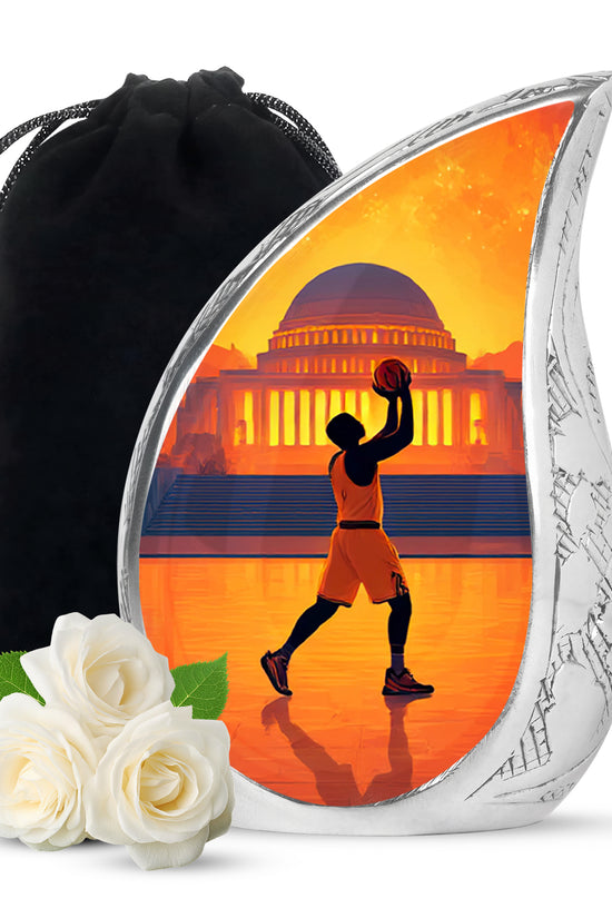 Garnet Red Basketball Cremation Urn front view showing detailed design - flowing teardrop basketball silhouette on curved aluminum - full-size 10 inch 200 cubic inch adult cremation urn
