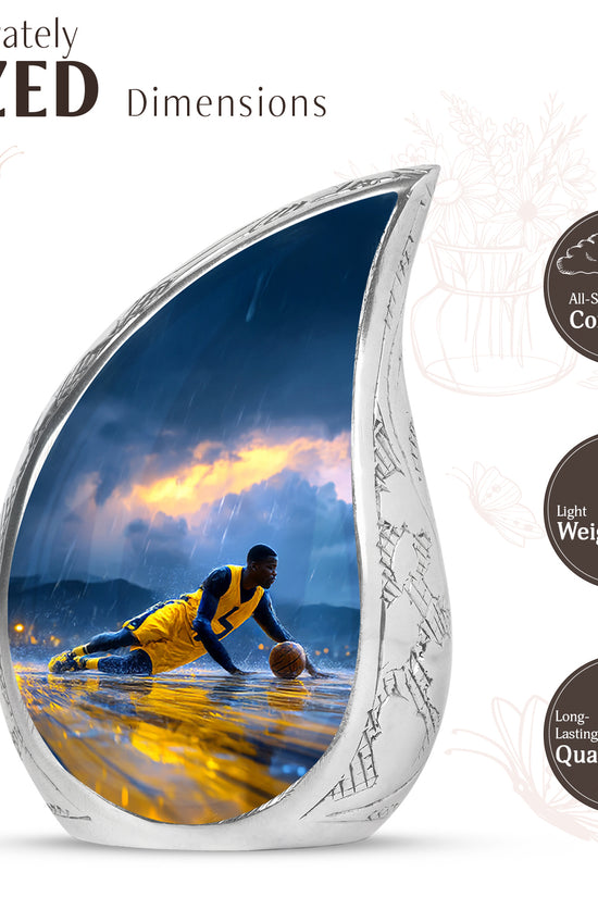 Misty Blue Basketball Cremation Urn angled view of lid and engraved motif - flowing teardrop basketball silhouette on curved aluminum - mini keepsake memorial for portion of cremation ashes