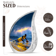 Misty Blue Basketball Cremation Urn angled view of lid and engraved motif - flowing teardrop basketball silhouette on curved aluminum - mini keepsake memorial for portion of cremation ashes