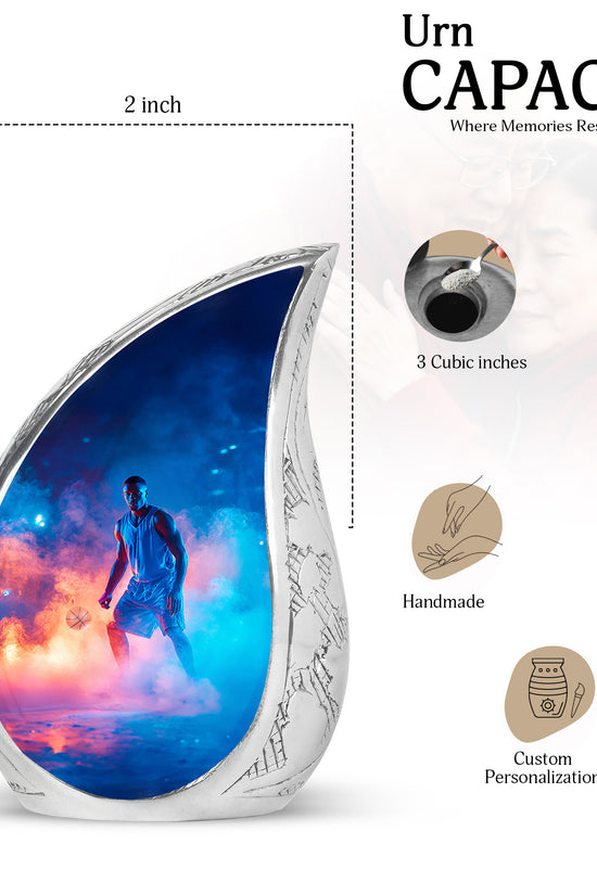 Azure Basketball Cremation Urn angled view of lid and engraved motif - flowing teardrop basketball silhouette on curved aluminum - mini keepsake memorial for portion of cremation ashes