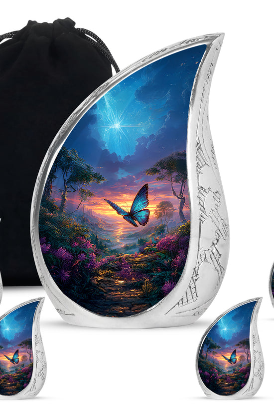 Dusty Blue Butterfly Cremation Urn side profile showing urn shape - flowing teardrop butterfly silhouette on curved aluminum - memorial set with one large and four small urns