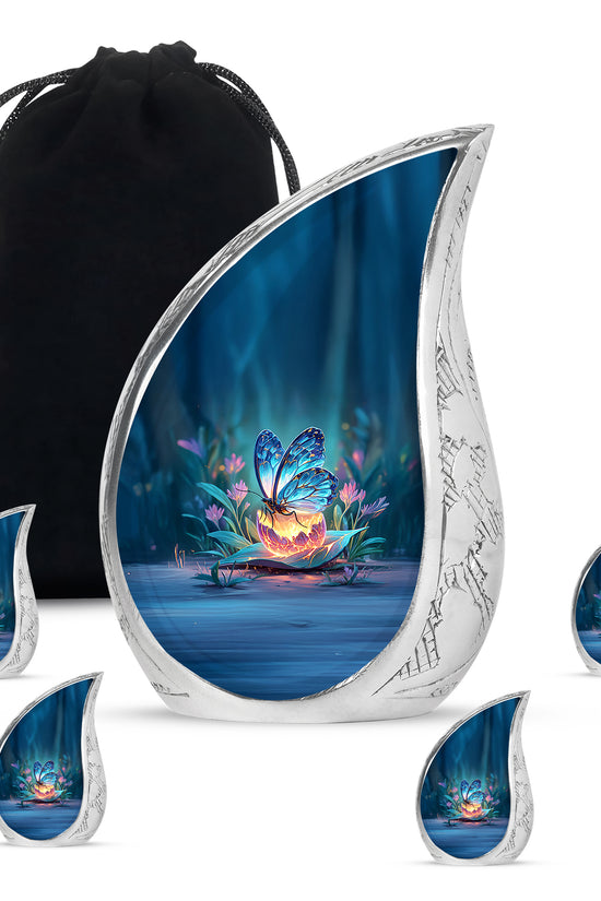 Indigo Butterfly Cremation Urn side profile showing urn shape - rounded teardrop butterfly design with delicate detail - memorial set with one large and four small urns