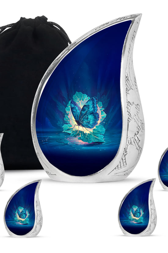 Azure Butterfly Cremation Urn side profile showing urn shape - flowing teardrop butterfly silhouette on curved aluminum - memorial set with one large and four small urns