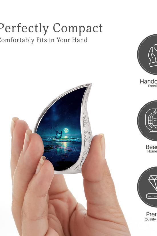 Sky Blue Butterfly Cremation Urn angled view of lid and engraved motif - flowing teardrop butterfly silhouette on curved aluminum - mini keepsake memorial for portion of cremation ashes