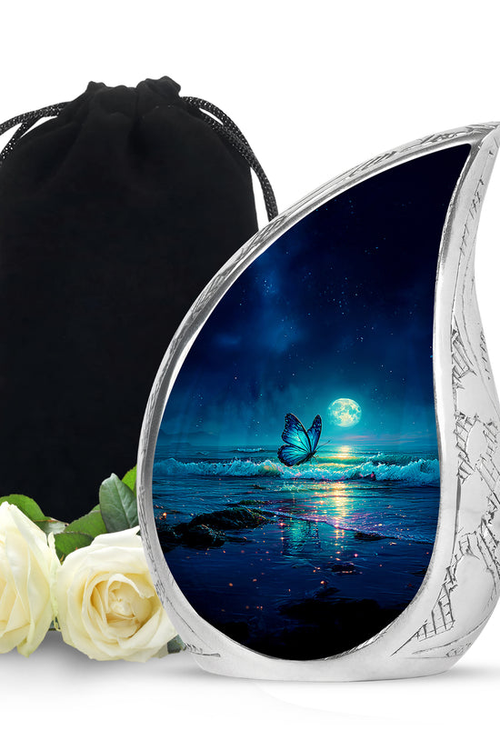 Indigo Butterfly Cremation Urn front view showing detailed design - flowing teardrop butterfly silhouette on curved aluminum - full-size 10 inch 200 cubic inch adult cremation urn