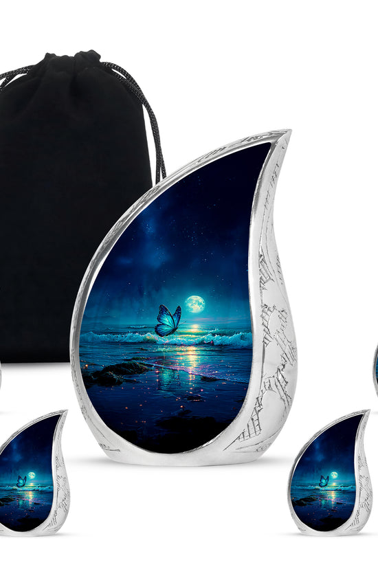 Dusty Blue Butterfly Cremation Urn side profile showing urn shape - flowing teardrop butterfly silhouette on curved aluminum - memorial set with one large and four small urns