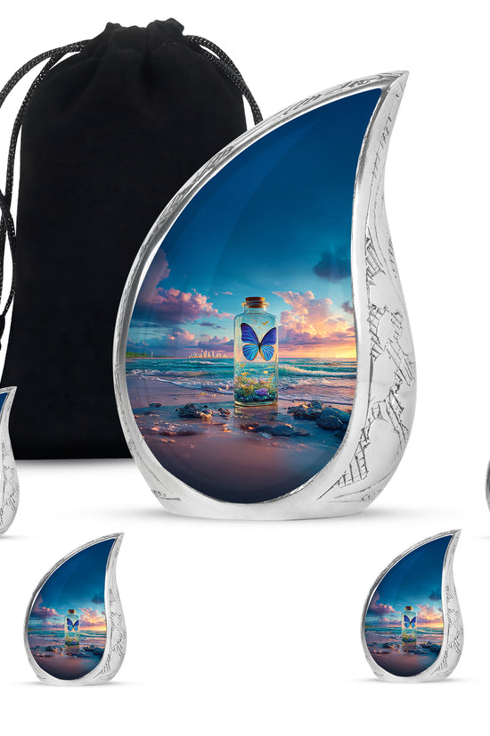 Sky Blue Butterfly Cremation Urn side profile showing urn shape - flowing teardrop butterfly silhouette on curved aluminum - memorial set with one large and four small urns