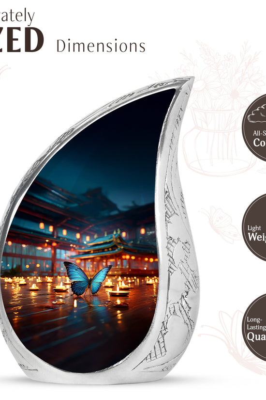 Slate Blue Butterfly Cremation Urn angled view of lid and engraved motif - flowing teardrop butterfly silhouette on curved aluminum - mini keepsake memorial for portion of cremation ashes