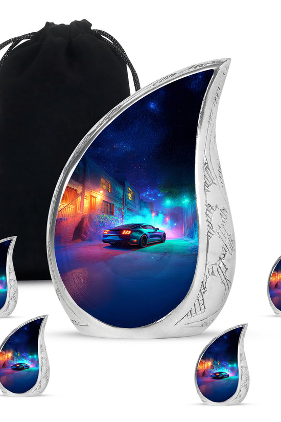 Celestial Blue Car Cremation Urn side profile showing urn shape - flowing teardrop car silhouette on curved aluminum - memorial set with one large and four small urns