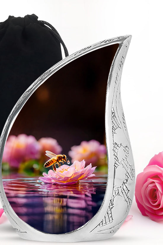 Rich Black Bee Cremation Urn front view showing detailed design - flowing teardrop bee silhouette on curved aluminum - full-size 10 inch 200 cubic inch adult cremation urn